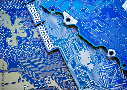 Circuit board close-up picture. Blue industrial background.