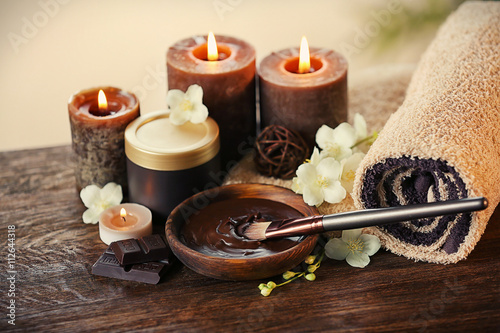 Spa chocolate set with candles on blurred background