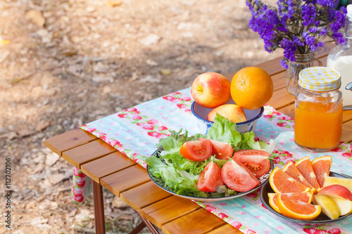 picnic, picnic set with orange juice fruit and vegetable at outdoor camping