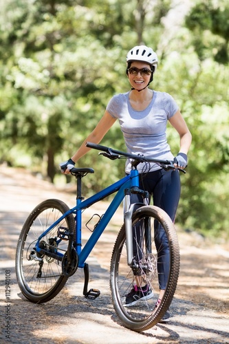 Woman smiling and posing with her bike