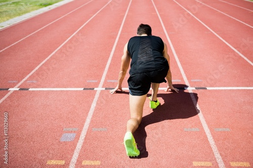 Rear view of an athlete ready to run
