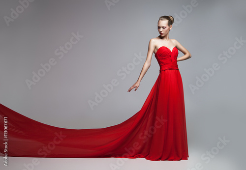 Model with flying skirt of red dress