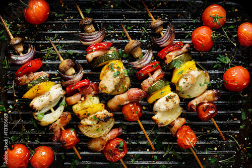 Grilled vegetable and meat skewers in a herb marinade on a grill pan, top view