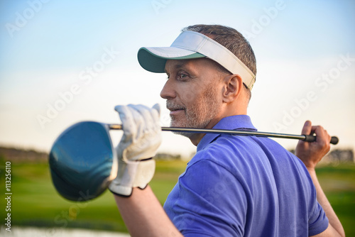 Golf player holding driver