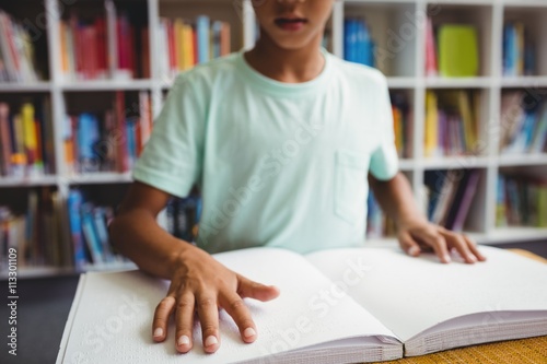 Boy using braille to read