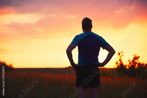 Pensive runner at the sunset