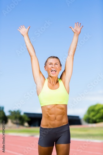 Excited female athlete posing after a victory