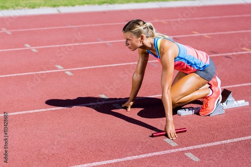 Female athlete ready to start the relay race 