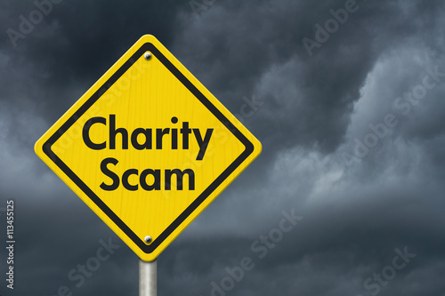 Charity Scam yellow warning highway road sign