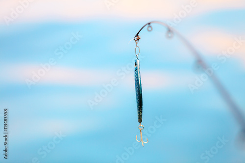 saltwater fishing - rod with wobbler and blue sea water