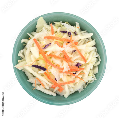 Bowl filled with coleslaw isolated on a white background top view.