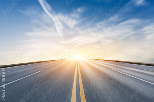 Fuzzy motion asphalt highway at sunset scene
