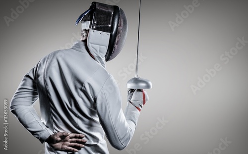 Composite image of man wearing fencing suit practicing with sword
