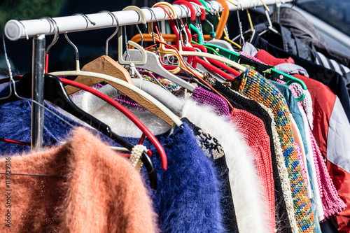 colored second hand women's sweaters at flea market