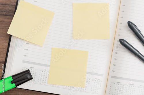 Calendar with memo notes and pen on desk
