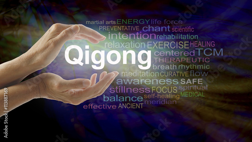 Gigong word cloud and healing hands - female cupped hands with the word QIGONG between surrounded by word cloud on a multicolored light centered dark background