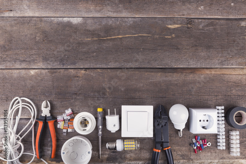 electrical tools and equipment on wooden background with copy space