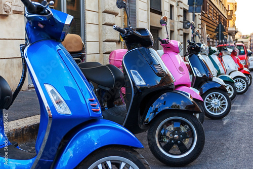 Multi-colored scooters vespa. Rental scooter in the city