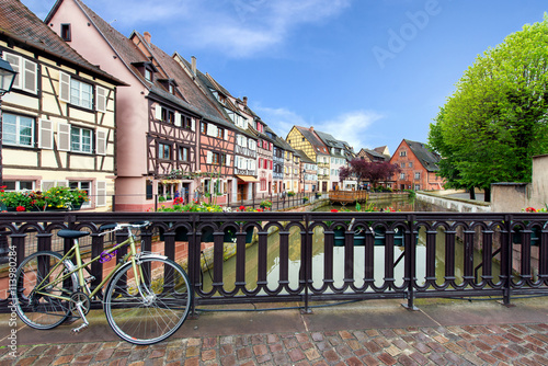 Colmar colorful traditional french houses with bicycle on the si