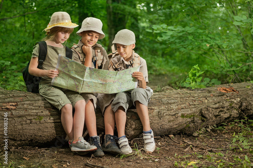 summer camps,scout children camping and read map in forest