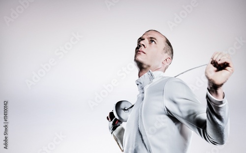 Composite image of swordsman holding fencing sword