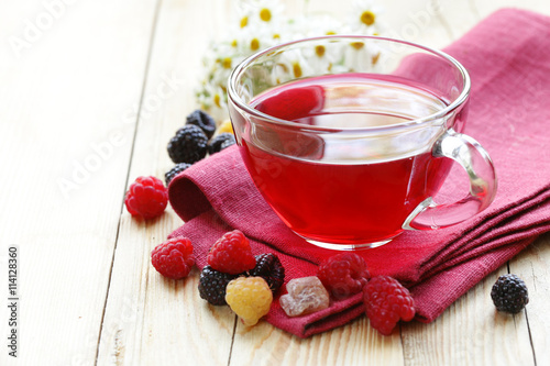 cherry fruit tea in a glass cup and fresh berries