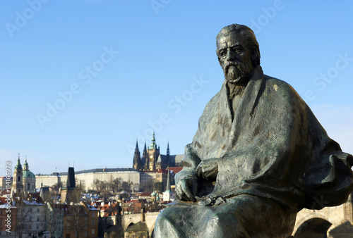  statue of composer Bedrich Smetana with Prague Castle and Charles Bridge background.