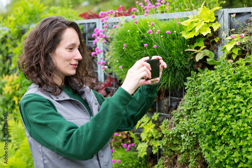 Young attractive landscaper woman working in a public park