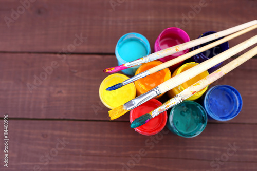 Multicolored plastic cans with paints. Artist workplace background. Art tools. Paints background. Colorful artist palette. Soft toned. Creativity, visual art concept. Art and craft. Closeup