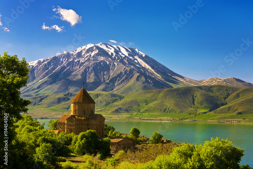 Turkey. Akdamar Island in Van Lake. The Armenian Cathedral Church of the Holy Cross (from 10th century). The dormant volcano Mount Cadir (Cadir Dagi) in the background