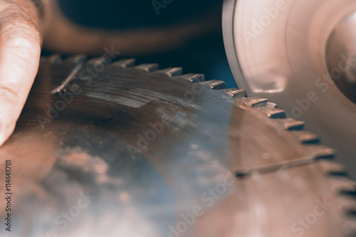 Sharpening Circular Saw, worker sharpens a circular saw blade