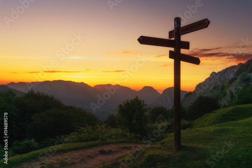 signpost in the mountain at sunset