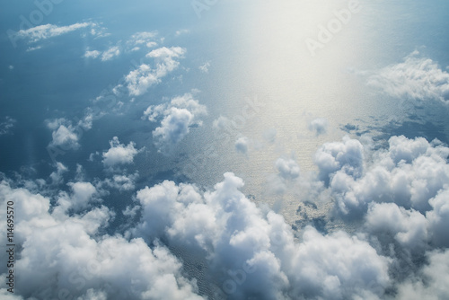 Clouds, sky and sea as seen in window of an aircraft