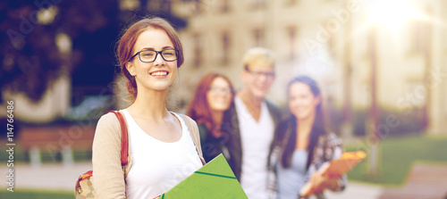 happy teenage students with school folders