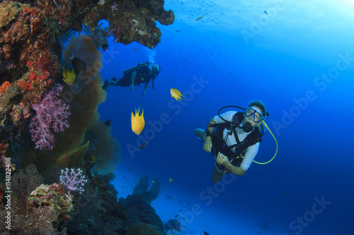 Scuba diving exploring coral reef