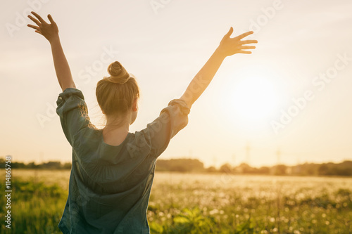 female teen girl stand feel freedom with arms stretched to the sky