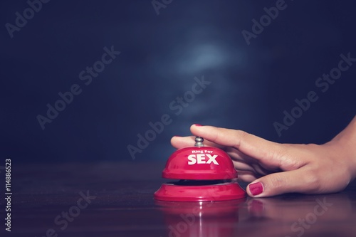 woman's hands press sex bell on a reception bell. concept about