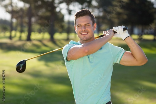 Portrait of handsome man with golf club 