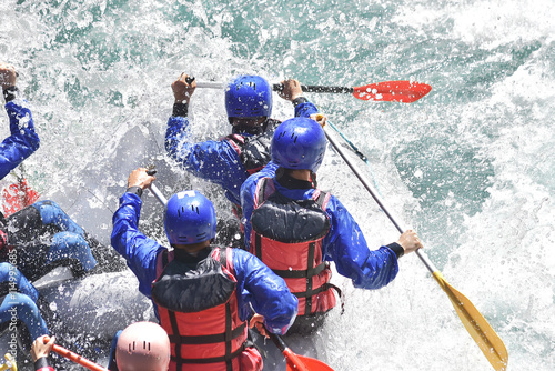 Rafting team splashing the waves