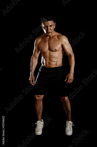 40s hispanic sport man and bodybuilder in gym corporate pose with naked torso muscular body