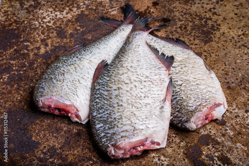 Three fresh bream on an old sheet