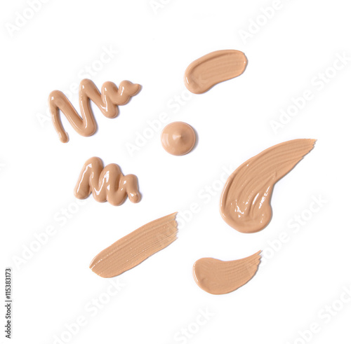 Smears of medium colored foundation make up isolated on a white background