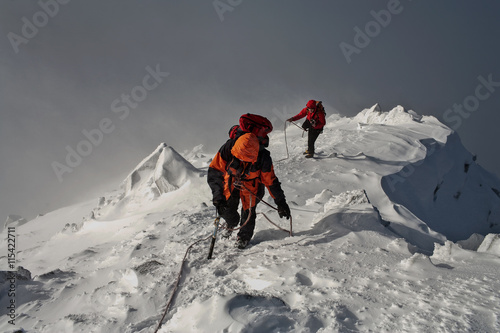 Climbing in mountains. Team work.