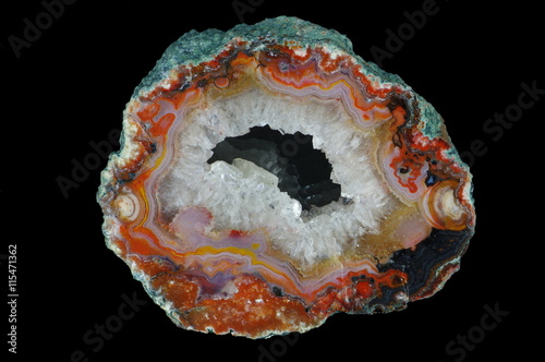 A cross section of the agate stone with geode on the black background. Origin: Asni, Morocco.