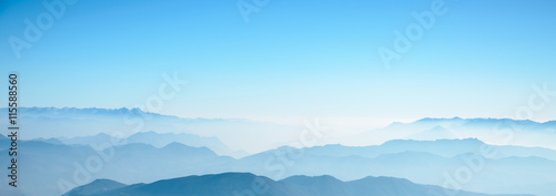 mountain in fog with blue sky landscape.
