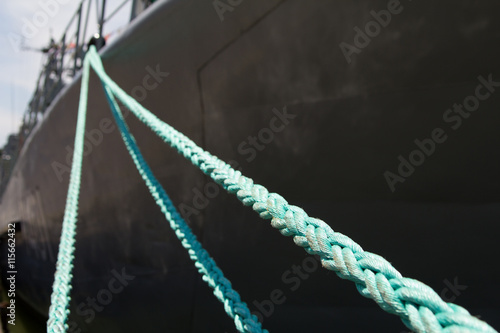 mooring rope holding the ship at the pier