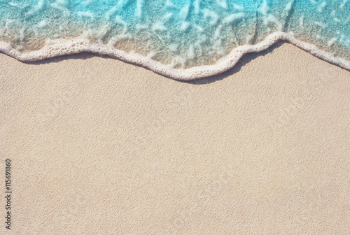 Soft ocean wave on the sandy beach, background.