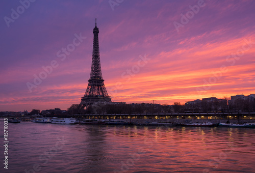 Fiery sunrise on the Eiffel Tower and Seine River in winter. Port de Suffren, Grenelle, 15th and 7th Arrondissements of Paris, France