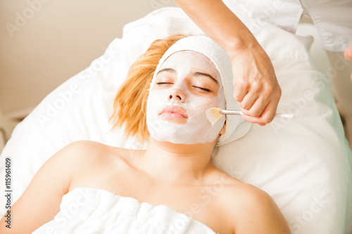 Woman getting a cream mask at the spa