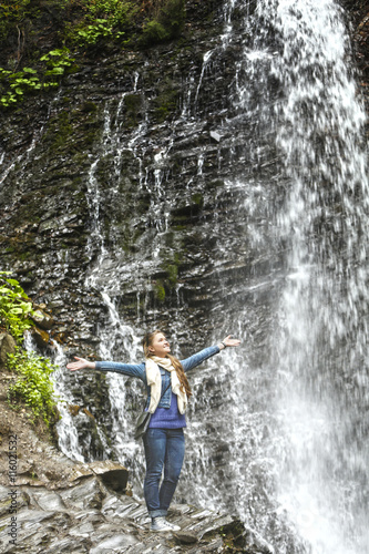 Woman on amazing waterfall background